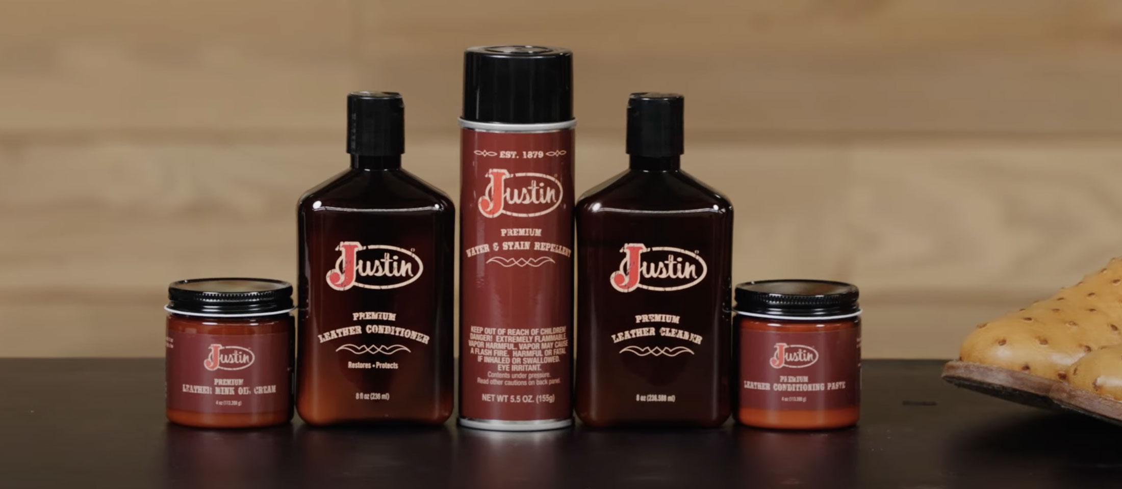 Shoe care products including leather conditioner, water and stain repellent spray, leather cleaner, and leather: mink and oil cream placed on a table.